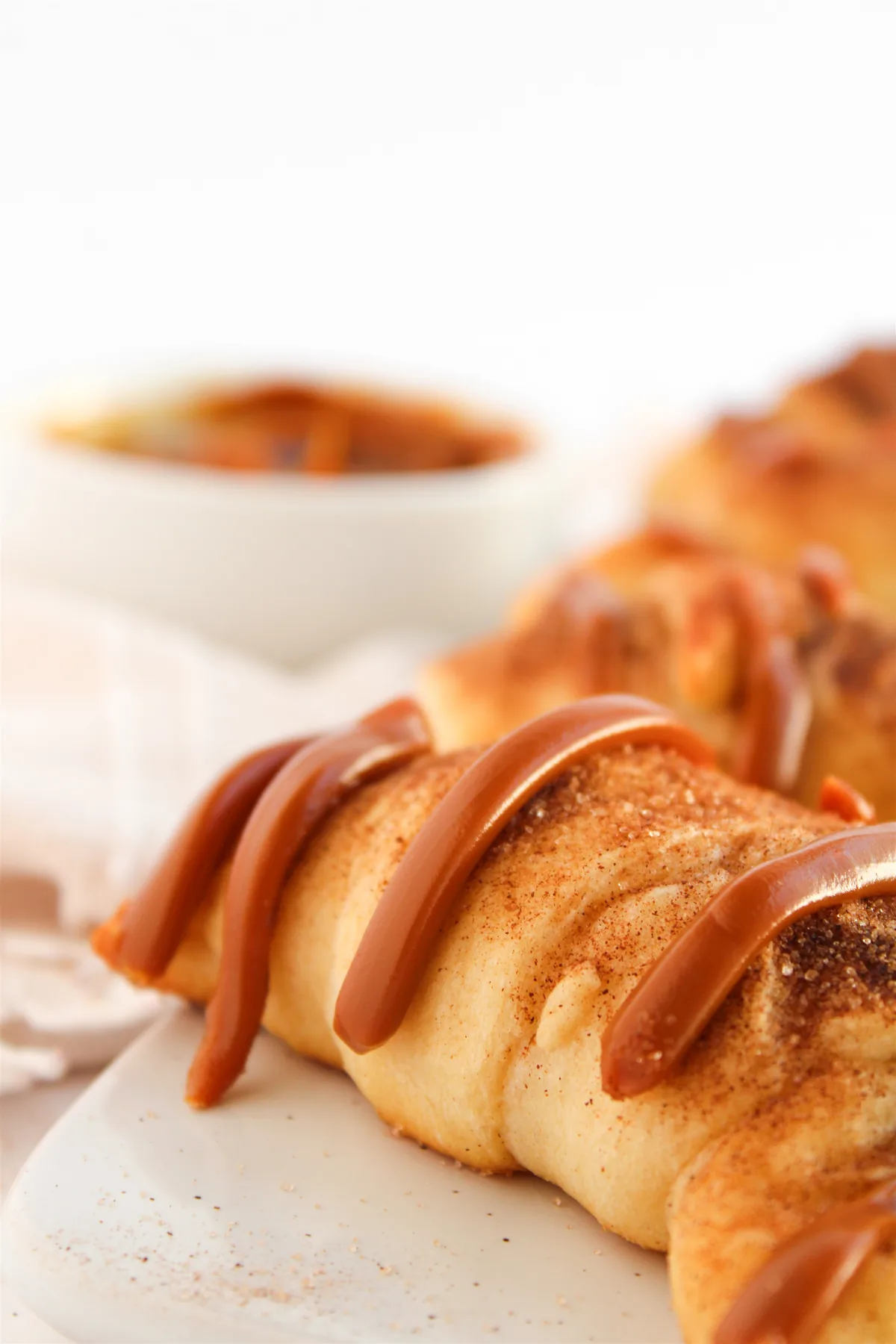 Easy Crescent Roll Churros With Dulce de Leche Close-up of a crescent roll churro with a dulce de leche drizzle