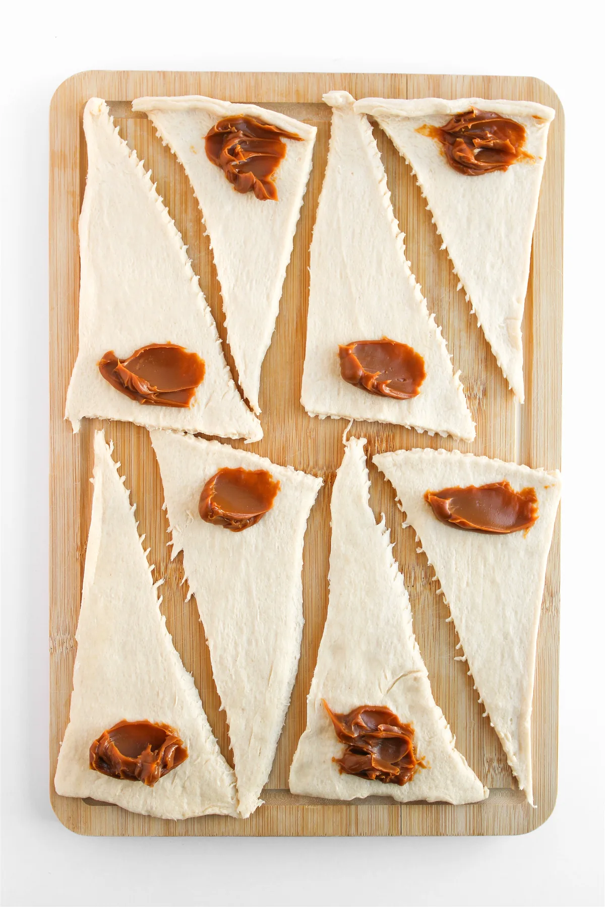 Easy Crescent Roll Churros With Dulce de Leche Crescent dough triangles with a spoonful of dulce de leche on the wide end of each