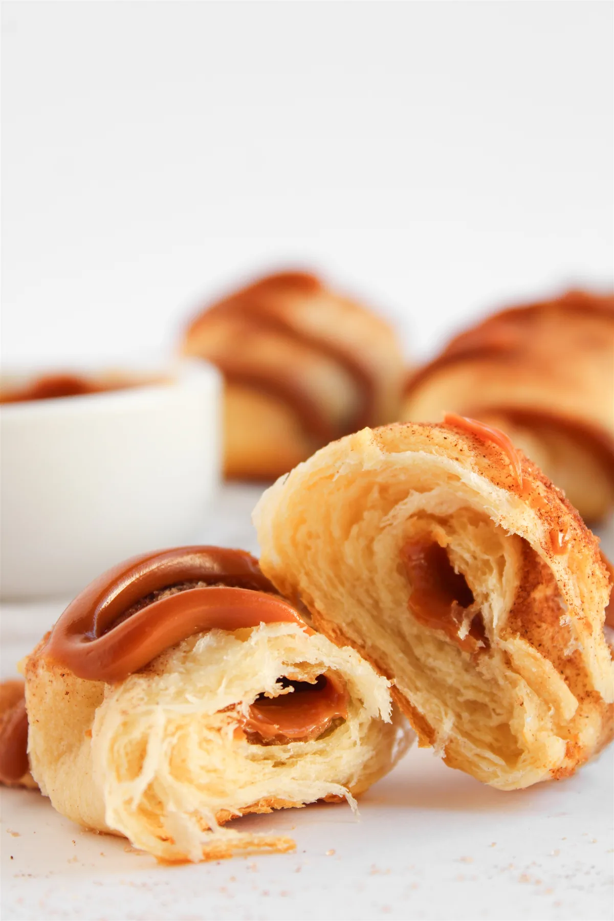 Easy Crescent Roll Churros With Dulce de Leche Crescent roll churro cut in half showing the dulce de leche filling