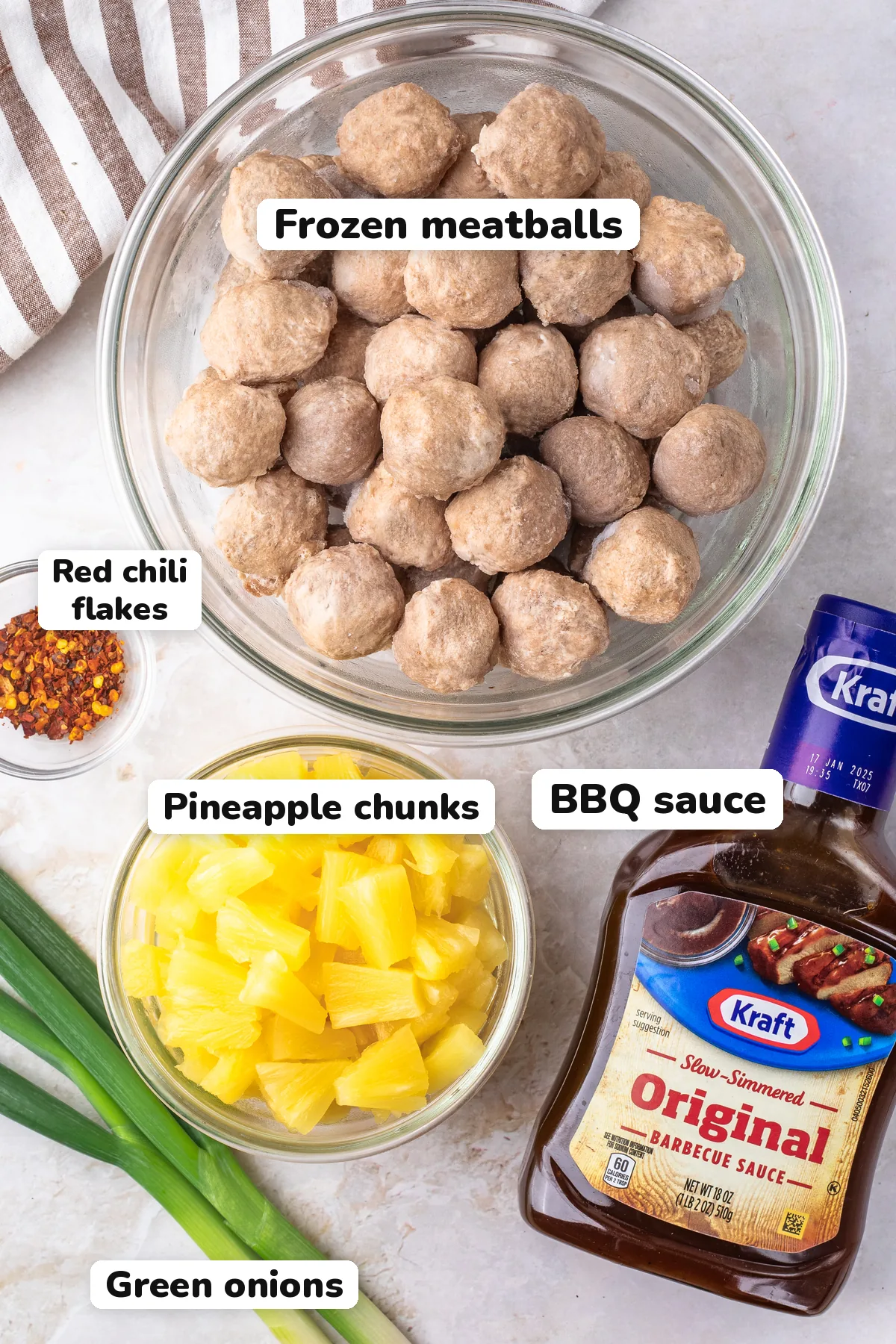 Labeled ingredients for Hawaiian meatballs: frozen meatballs, BBQ sauce, pineapple chunks, red chili flakes and green onions