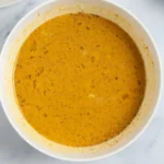 Pumpkin spice custard whisked smooth in a white bowl