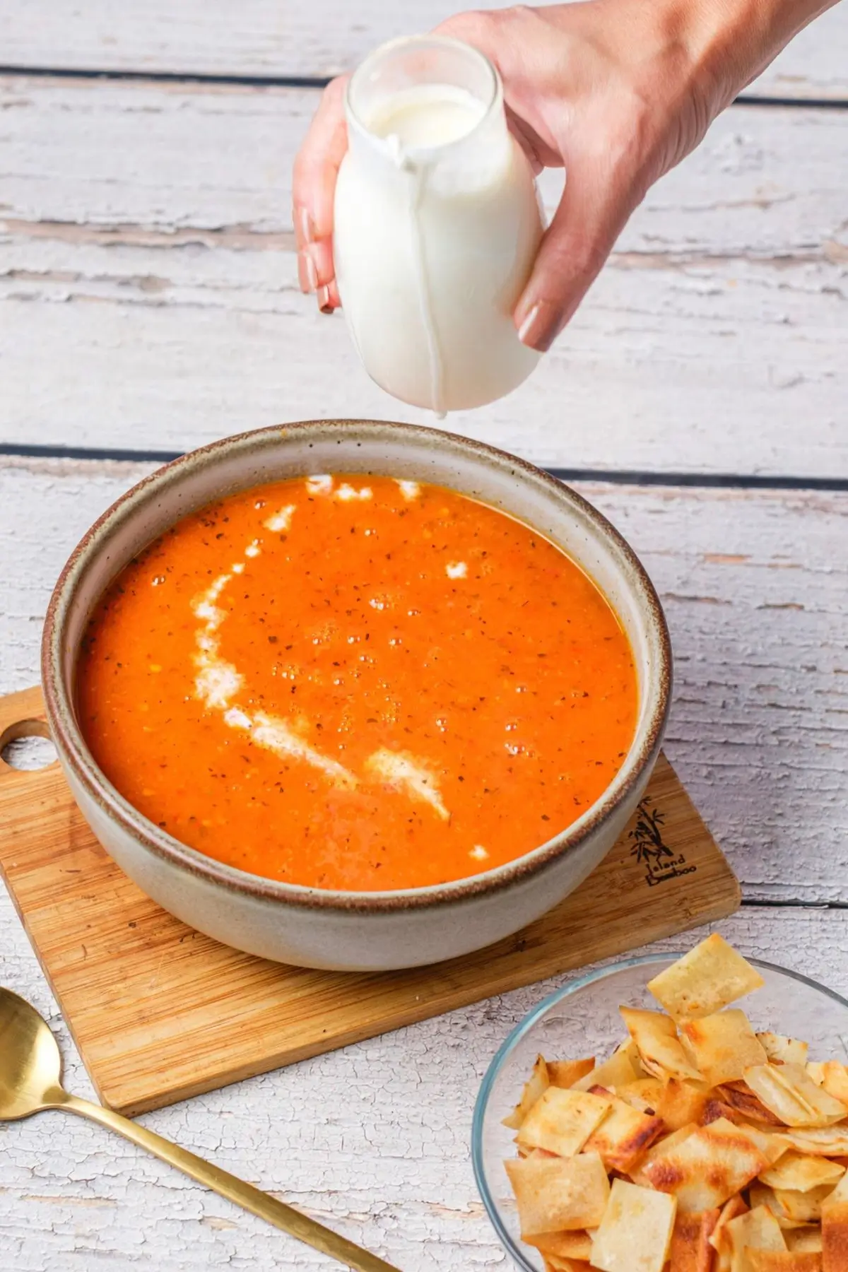Tomato Bisque Soup With Fresh Tomatoes (Small Batch for Two) Pouring heavy cream into a bowl of tomato bisque to make a swirl