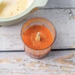 Tomato Bisque Soup With Fresh Tomatoes (Small Batch for Two) Blended tomato soup in a blender cup next to the empty pot