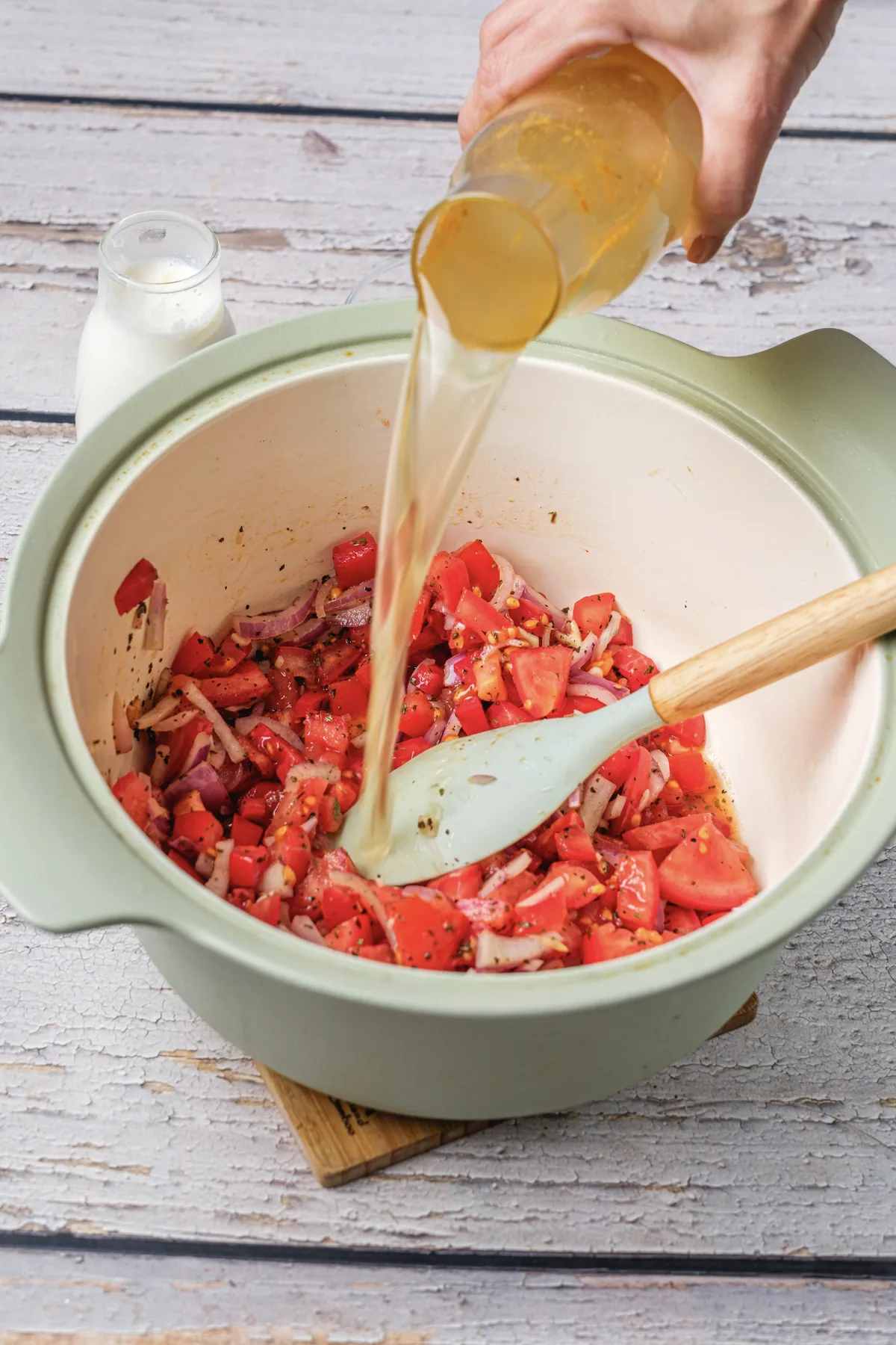 Tomato Bisque Soup With Fresh Tomatoes (Small Batch for Two) Pouring broth over the chopped tomatoes in the soup pot