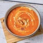 Tomato Bisque Soup With Fresh Tomatoes (Small Batch for Two) Bowl of tomato bisque soup with a cream swirl and croutons