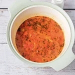 Tomato Bisque Soup With Fresh Tomatoes (Small Batch for Two) Tomato soup after simmering, with the tomatoes broken down and flecks of basil